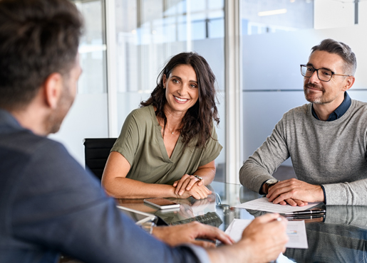 Couple at table talking with mortgage advisor