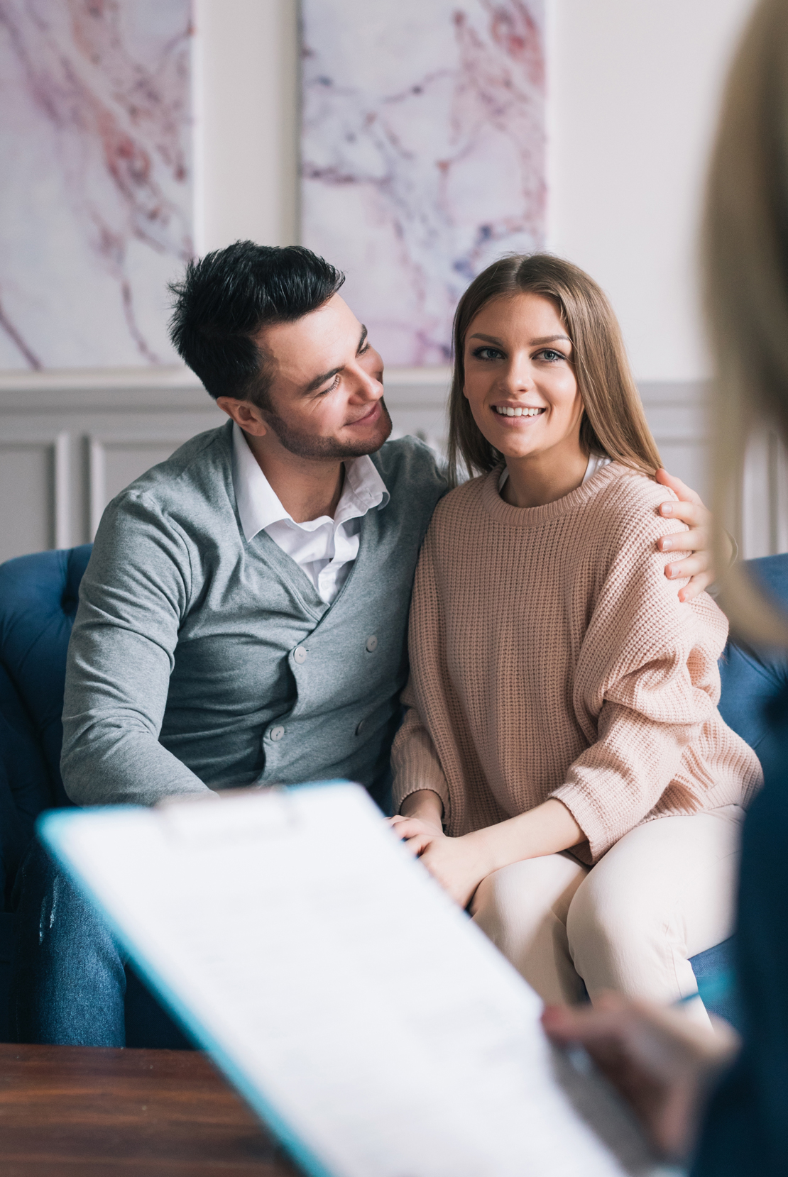 Couple sitting in living area talking to advisor